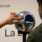 2139240312 a man has his iris scanned with an orb a biometric data scanning device in exchange for t