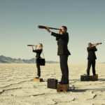 3 business people with telescopes
