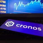 Cronos CRO logo is displayed on a smartphone screen 1024x683