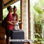 SOCIAL IMAGE PARTNER OFFER TERMS APPLY Couple standing near window at villa with suitcase Klaus Vedf
