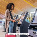 SOCIAL IMAGE PARTNER OFFER TERMS APPLY woman using the check in machine at the airport David Prado 7