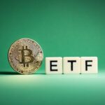 bitcoin coin beside letter blocks spelling etf on a green background