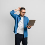 confused investor with laptop