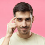 getty finger on forehead head smart move savvy good idea