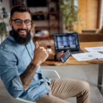 happy stock investor holding smartphone