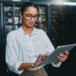 person in a data center using a tablet computer