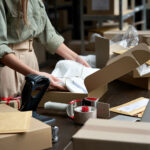 person packing shipping boxes