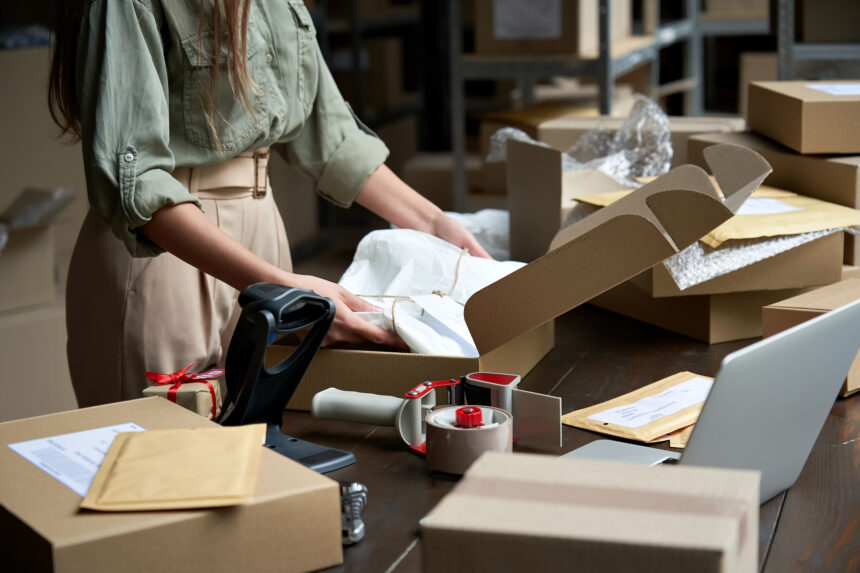 person packing shipping boxes