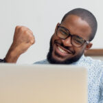 smiling man holding fist up