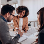 three investors meet with paperwork