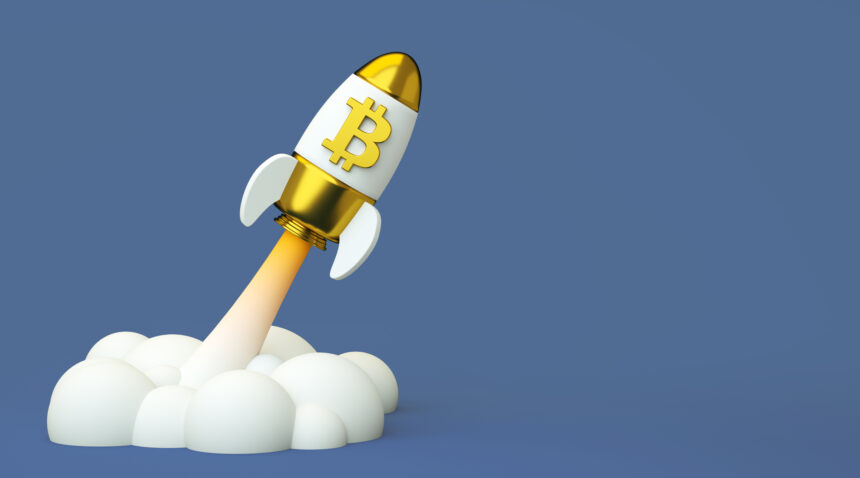 toy spaceship with bitcoin logo launching