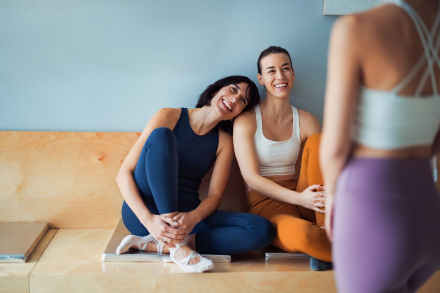 yoga athleisure lululemon three women hanging out in a yoga studio