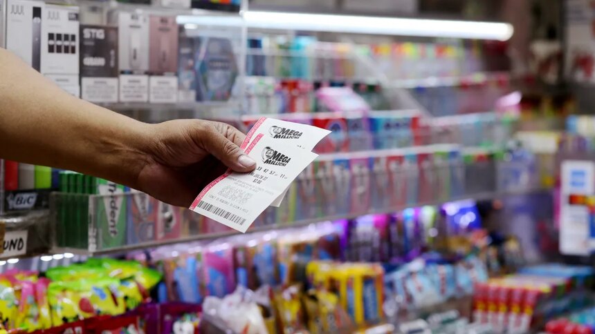 Mega Millions Jackpot Reaches $650 Million After Three-Month Streak 1 man holding mega millions