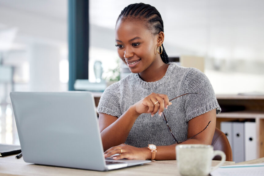 woman smiling looking at laptop