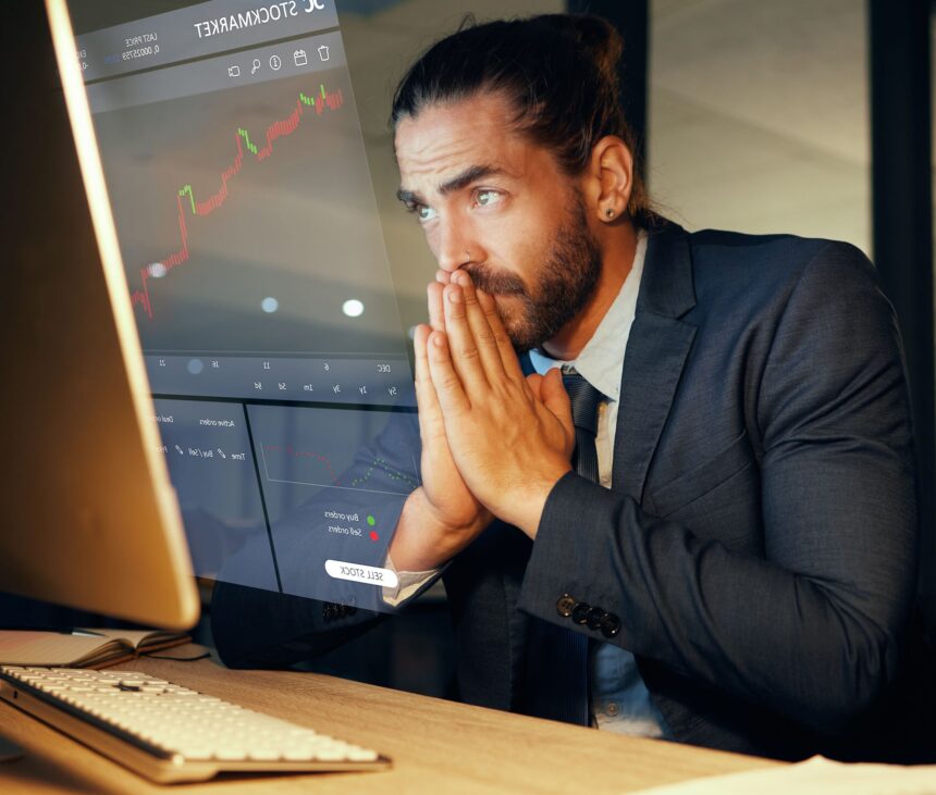 concerned investor looking at a stock chart on a computer