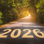 the year 2026 on a paved road coursing through a wooded area