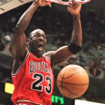 1155562590 michael jordan of the chicago bulls hang son the rim after a dunk 05 june against the uta