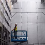 1235927074 a worker installs a new row of bitcoin mining machines at the whinstone us bitcoin mining