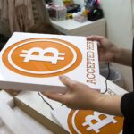 475512651 hong kong a worker holds a sign at the first bitcoin retail store open in hong kong on