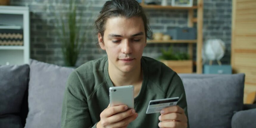 Centralized Exchanges Merge Traditional Finance with Crypto, Boosting Trading Volumes 1 person using a smartphone while holding a credit card