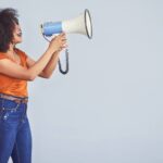 woman with bull horn message loud
