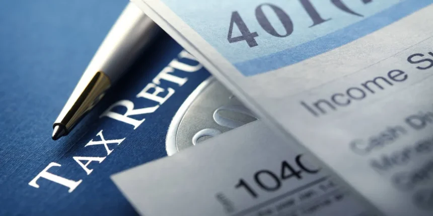 Record Number of US Workers Raiding Retirement Savings Amid Economic Uncertainty 1 a 401k statement rests on top of a us federal 1040 income tax return and is photographed using a ver