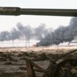 a kuwaiti oil field set afire by retreating iraqi troops burns in the distance 76d627