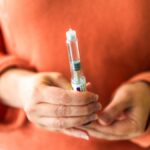 person holds injector