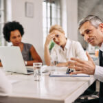 angry businessman discussing with colleague meeting office