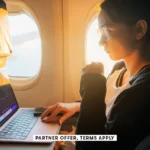 SOCIAL IMAGE PARTNER OFFER TERMS APPLY Woman working with laptop in the airplane Oleh Slobodeniuk 24