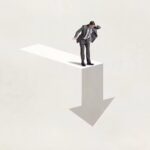 2153725067 man looks down at arrow