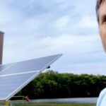kent haliburton standing in front of a solar panel at the bi 1 800x420